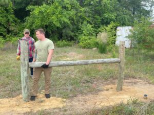 People learning to build a fence